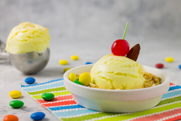Artisan ice cream on white plate with cloth and gray background.