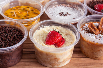 cakes in pot of various flavors on wooden background