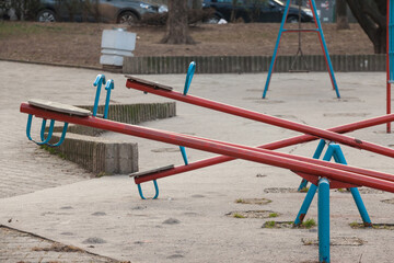 Selective blur and Close up on an empty children see saw, or teeter totter in a playground, with nobody. This type of swing is used by kids for enjoyment. ....