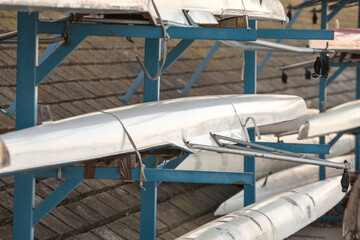 Selective blur on Rowing boats, Sweep oar and coxed four style, being stored and maintained at...