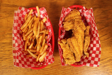 Top view of french fries and fried catfish at a fast-food diner