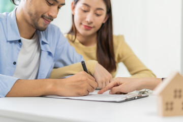 Obraz premium Happy asian couple client, tenant buyer home ,apartment, sign signature contract rental, purchase. Landlord, realtor agreement after bank approve mortgage, loan success or done. Property agent concept