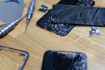 Bangkok, Thailand - 29 May 2021: Close-up shot of the broken screen of the iPhone 11 with tools...