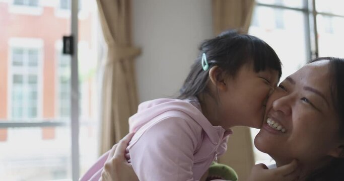 4K Video slow motion Asian mom and little daughter play and kiss each other. Concept of love and connection of mother and kid.