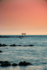 tori gate over the sea at sunset 