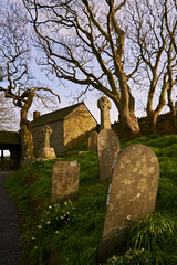 old stone church and cemetery at sunset