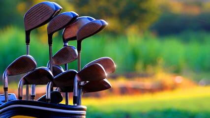 Golf clubs drivers over green field background,Golf clubs in bag golf equipment on golf stadium background