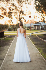 Fototapeta na wymiar Girl in debutante outfit from behind in beautiful afternoon sun, no face visible