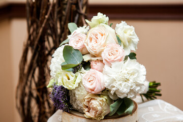wedding bouquet of the bride in light colors with pink roses, white eustoma with the addition of eucalyptus