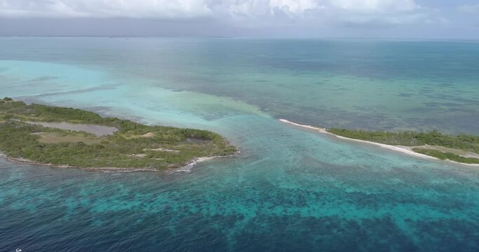 Moving turn left to rigth Cote barrier reef aerial view cay  and shallow turquoise waters in Los Roques venezuela,  blue water and Green mangrove