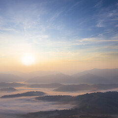 mountain valley in blue mist at the early morning, natural travel background