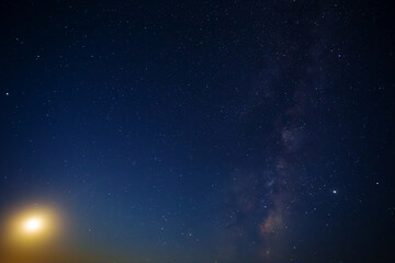 Fototapeta na wymiar night starry sky with milky way and rising moon