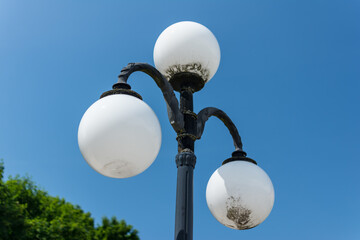 the white street lamp is turned off in the Park during the day. autumn sky.