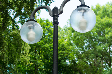 the white street lamp is turned off in the Park during the day. autumn sky.