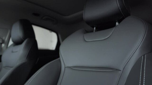 The interior of a luxury car with leather upholstery seats.