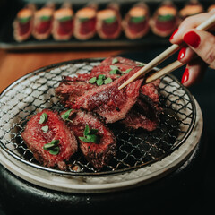 hand grabbing steak on restaurant table