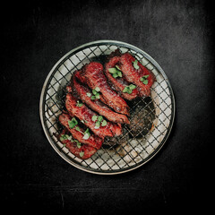 asian steak cooked on steamed stones on a black background