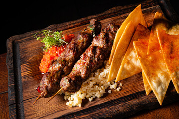 Barbecued kofta - kebeb with vegetables on a plate