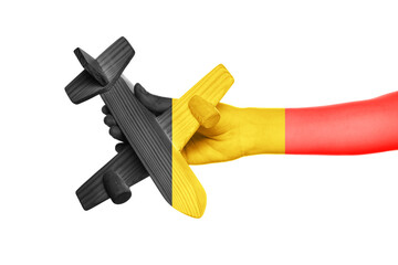 Human hand with airplane in colors of Belgian flag on white background