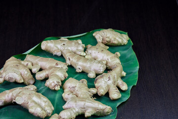 closeup ginger root isolated on green leaf