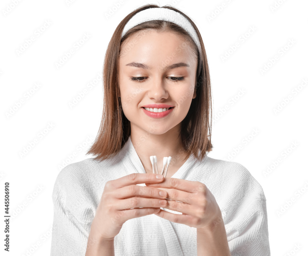 Wall mural Young woman with cotton buds on white background