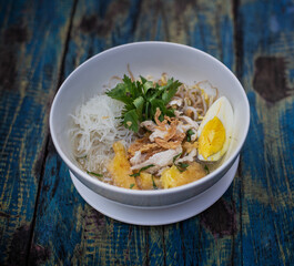 Cassava broth. Creamy broth made with cassava, vermicelli, bean sprouts, basil leaves, eggs and meat in a bowl