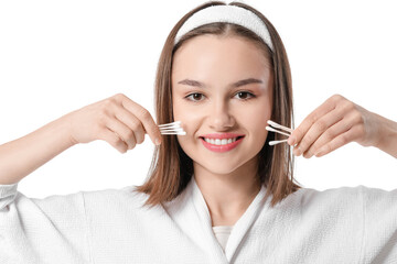 Young woman with cotton buds on white background