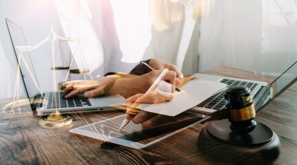 Business and lawyers discussing contract papers with brass scale on desk in office. Law, legal services, advice, justice and law concept picture with film grain effect