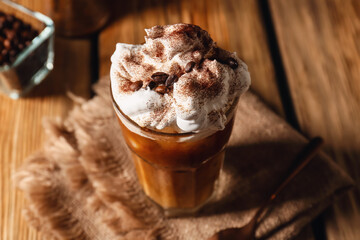 Glass of iced coffee on wooden table