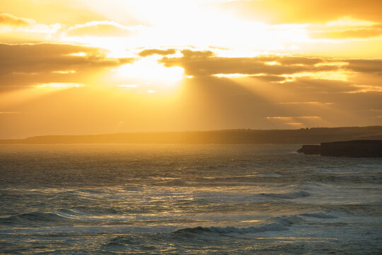 sunset over the sea in Australia, yellow colours and sun beams