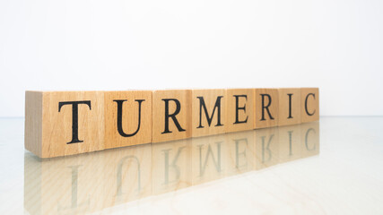 The word turmeric was created from wooden letter cubes. Gastronomy and spices.