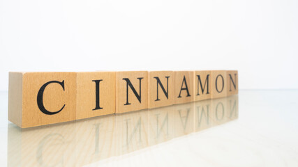 The word Cinnamon was created from wooden letter cubes. Gastronomy and spices.