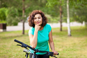 Fototapeta na wymiar Middle age senior woman on bike cycle ride in countryside park outdoor