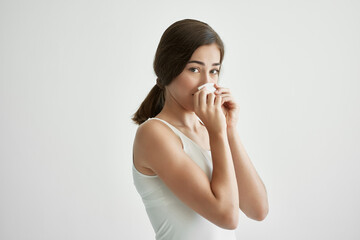 woman in white tank top handkerchief runny nose health problems