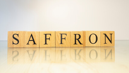 The word Saffron was created from wooden letter cubes. Gastronomy and spices.