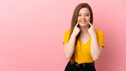 Teenager girl over isolated pink background smiling with a happy and pleasant expression