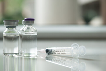 Selective Focus of Syringe and Medicine in vial , ready for vaccine injection , Cancer Treatment , Pain Treatment and can also be abused for an illegal use, healthcare and medical concept vaccination.
