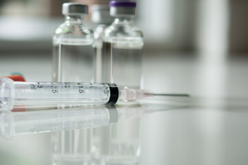 Selective Focus of Syringe and Medicine in vial , ready for vaccine injection , Cancer Treatment , Pain Treatment and can also be abused for an illegal use, healthcare and medical concept vaccination.