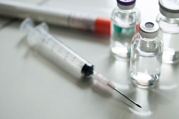 Selective Focus of Syringe and Medicine in vial , ready for vaccine injection , Cancer Treatment , Pain Treatment and can also be abused for an illegal use, healthcare and medical concept vaccination.