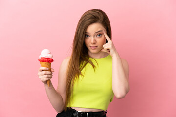 Teenager girl with a cornet ice cream over isolated pink background thinking an idea