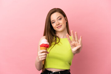 Teenager girl with a cornet ice cream over isolated pink background happy and counting four with fingers