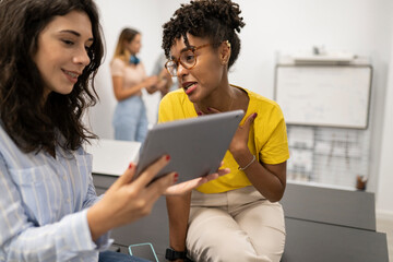 two women in coworking resting talking