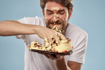 man holding cake smeared face birthday celebration fun