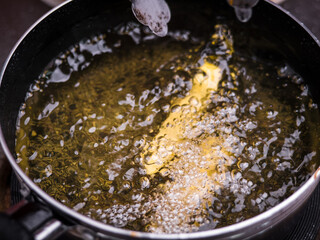 Close up of Frying french fries in the fryer in hot oil on the electric stove in the kitchen. Making homemade french fries.