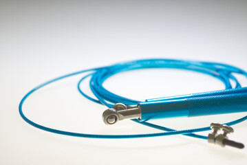 Blue roll of jumping rope in close range with white background