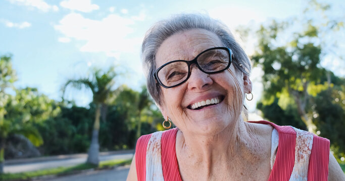 Smiling Old Latin Woman. Beautiful Senior Woman Looking At The Camera With A Warm Friendly Smile And Attentive Expression. Elderly Woman Laughing.