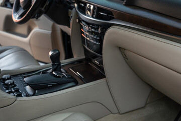 Fototapeta na wymiar Luxury car Interior - steering wheel, shift lever and dashboard. Interior detail of new modern car