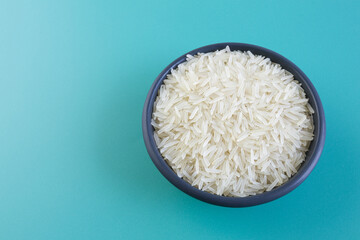 basmati rice in a black plate on a blue background