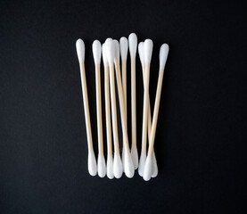 Recyclable bamboo cotton buds on black background