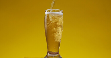 Cold Light Beer in a glass with water drops. Craft Beer close up.